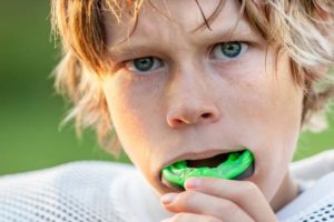Boy using mouthguard for football